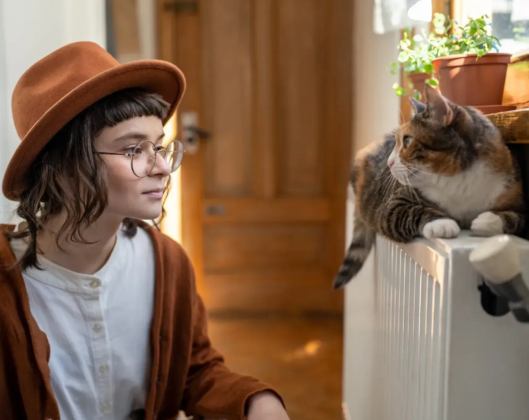 Interested woman cat owner in hat looks to fluffy 2026 01 08 22 10 36 utc