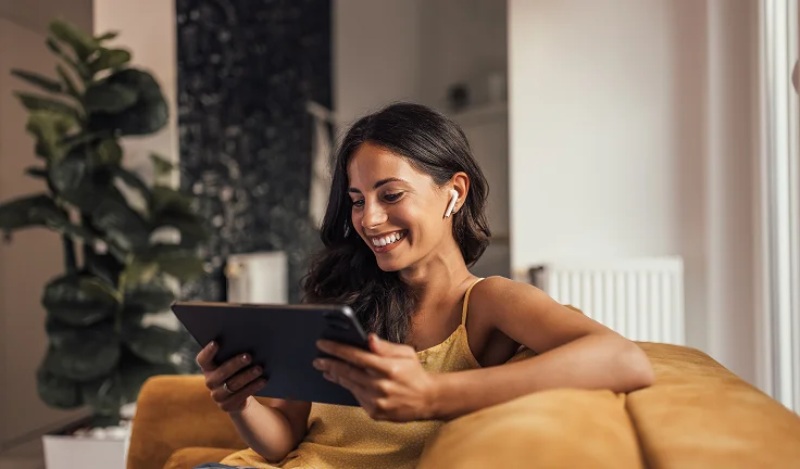 Woman Smiling at Tablet